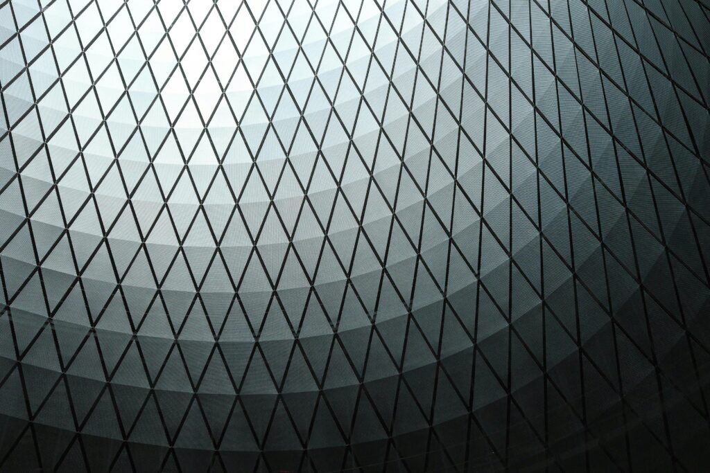 Abstract view of a geometric dome ceiling with a diamond pattern in black and white tones.